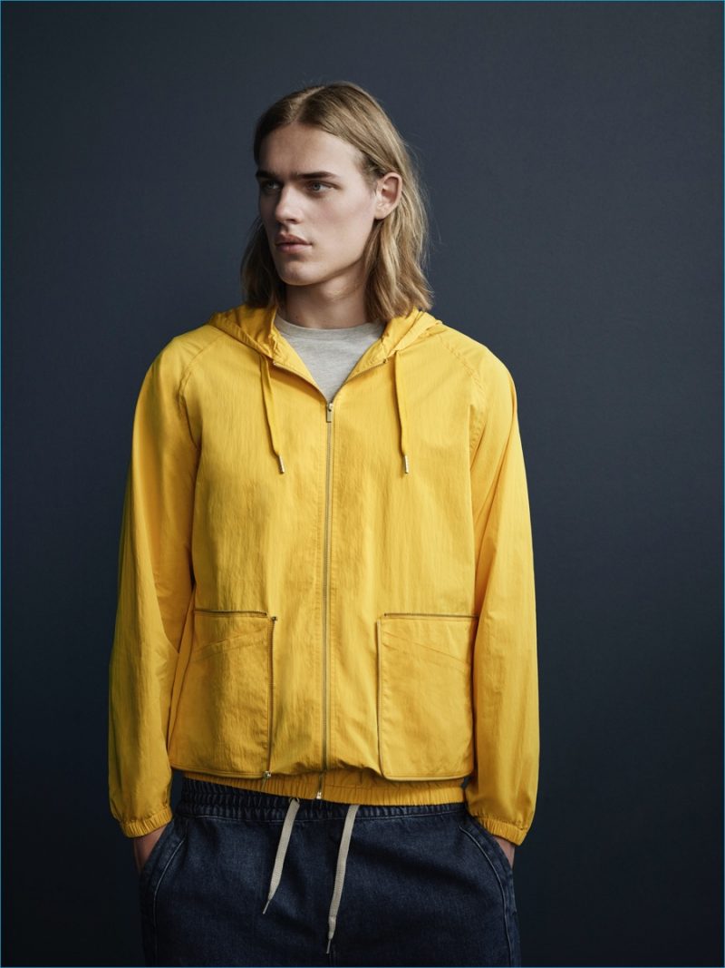 Ton Heukels sports a yellow packaway hoodie from YMC x River Island's collection.
