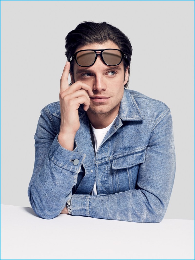 Sebastian Stan rocks Brioni sunglasses with a denim jacket from Calvin Klein Collection.