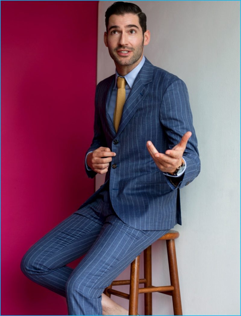 Tom Ellis charms in a grey pinstripe suit from Brunello Cucinelli.
