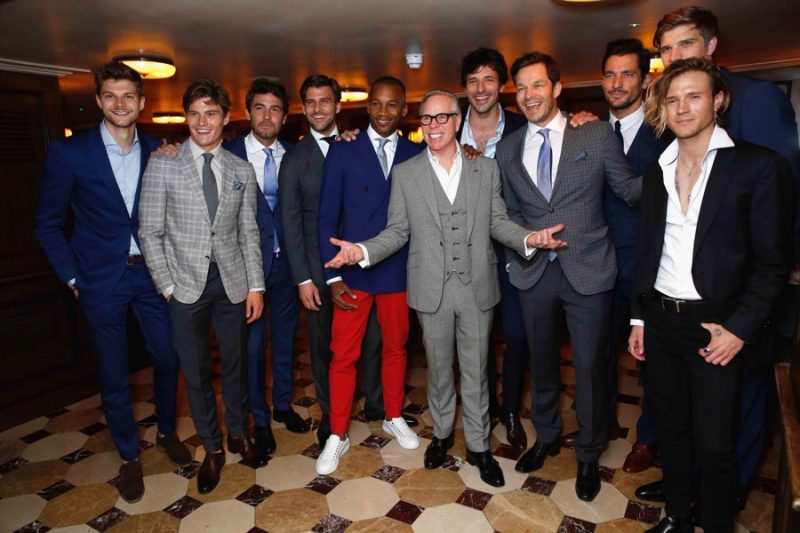 Tommy Hilfiger poses with guests at a London Collections: Men dinner.