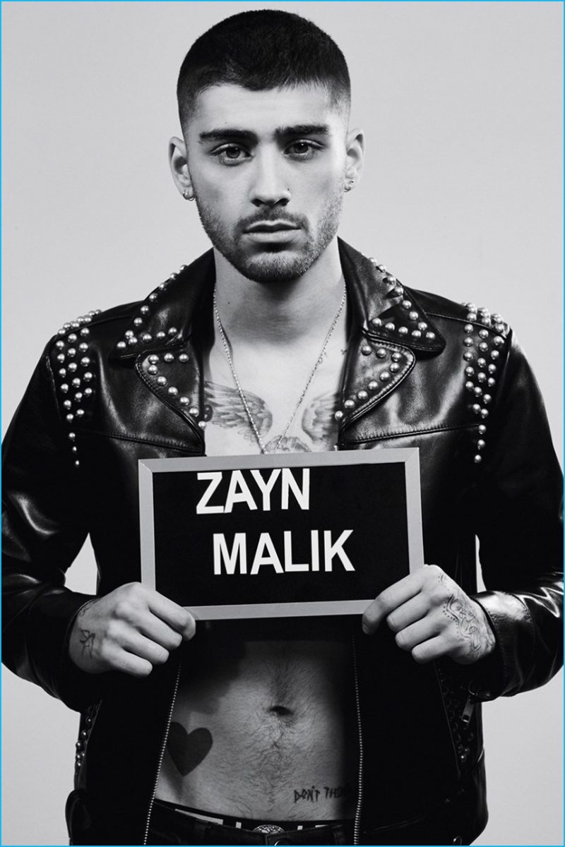 Zayn Malik poses for a mugshot, wearing a studded leather biker jacket from Marc Jacobs.