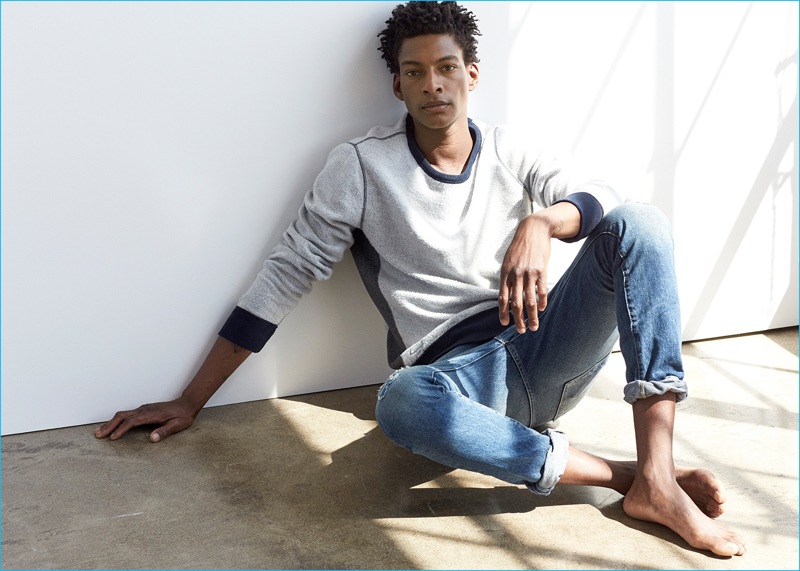 Ty Ogunkoya relaxes in distressed jeasn and a casual pullover for Abercrombie & Fitch's fall 2016 denim campaign.