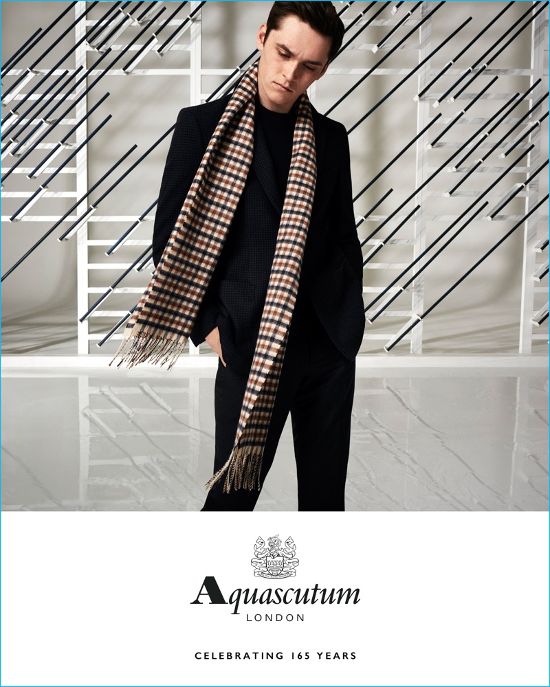 Anders Hayward wears a club check scarf and lean tailoring for Aquascutum's fall-winter 2016 campaign.