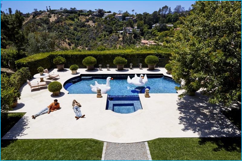 Dylan and Paris Brosnan are captured poolside for L'Uomo Vogue.