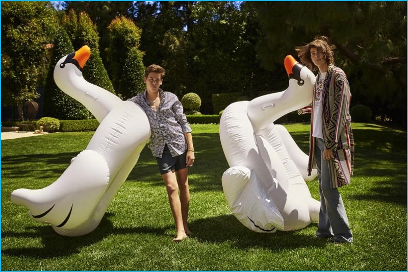 Paris and his brother Dylan poses for pictures outdoors with inflatable swans.