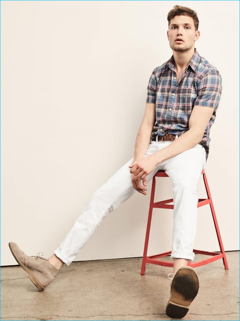 Gap stands by casual style with white denim jeans and a short sleeve plaid shirt.