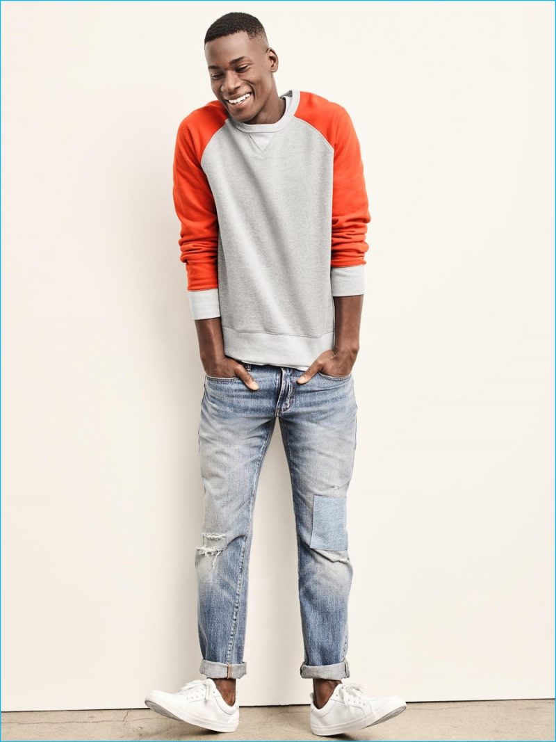 Gap embraces sporty style with a colorblocked baseball sweatshirt, paired with distressed denim jeans.