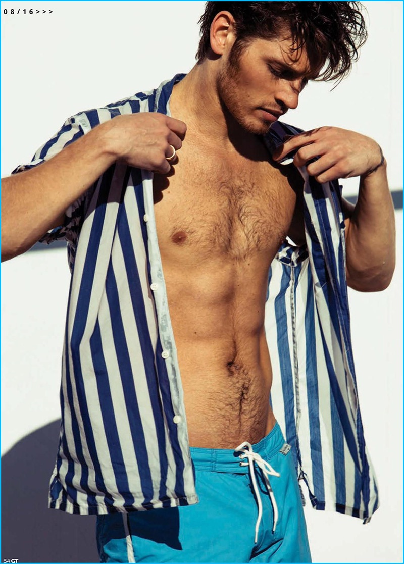 Gregg Sulkin sports a CPO striped shirt with Sandro swim shorts. 