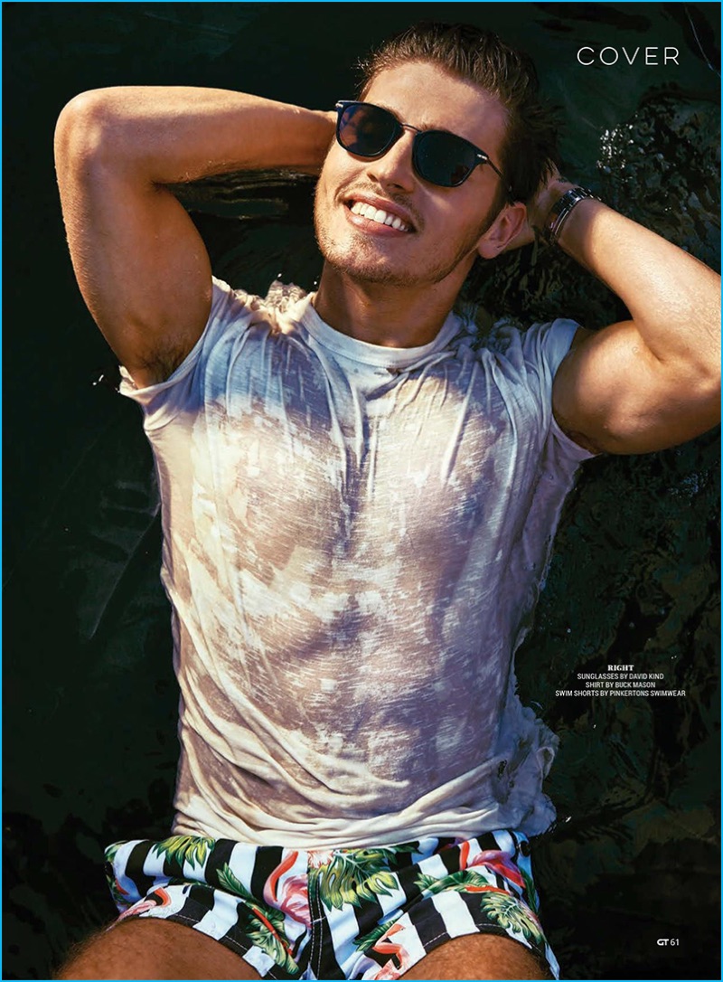 Styled by Tara Nichols, Gregg Sulkin is all smiles in a wet Buck Mason t-shirt and Pinkertons swimwear.