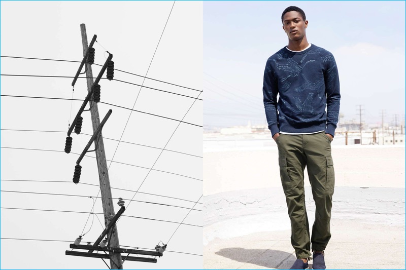 Hamid Onifade heads out in a graphic print sweatshirt, cargo pants and slip-on nubuck shoes from H&M.