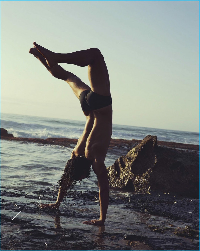 Jarrod Scott takes to the beach, completing a free spirited handstand. 