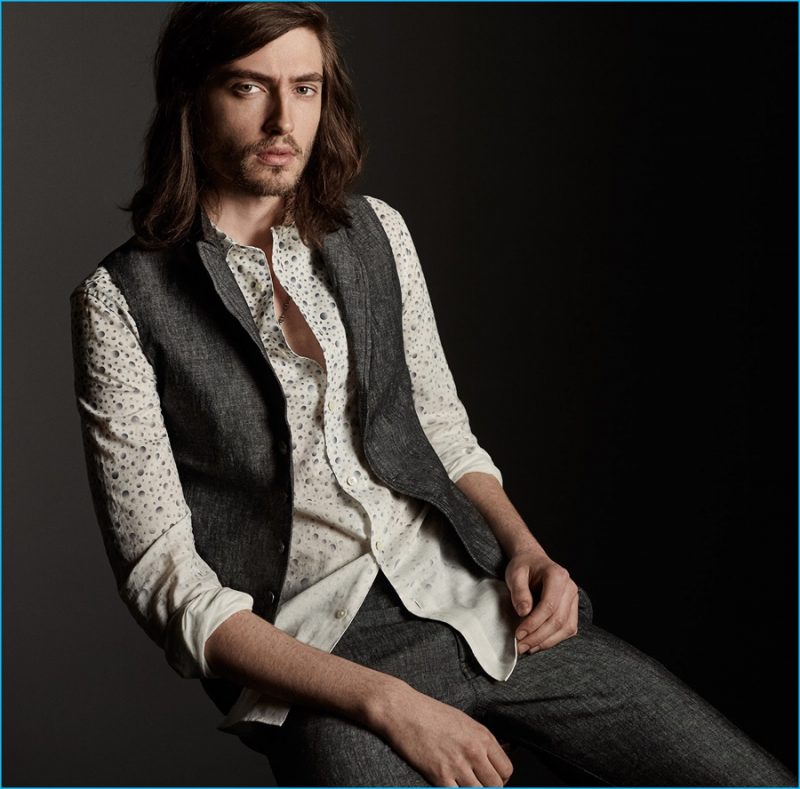 John Varvatos shows how to pull off its linen vest, pairing it with coordinating jeans and a patterned button-down shirt.