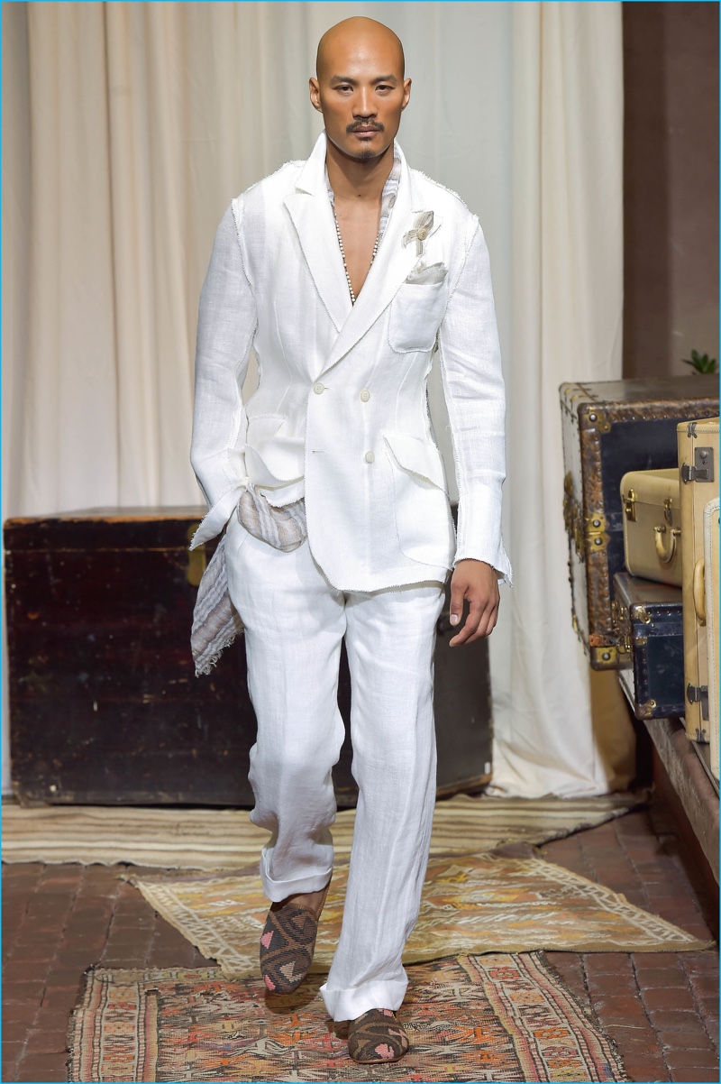 Paolo Roldan hits the rustic catwalk in a deconstructed, double-breasted white suit from Joseph Abboud's spring-summer 2017 collection.