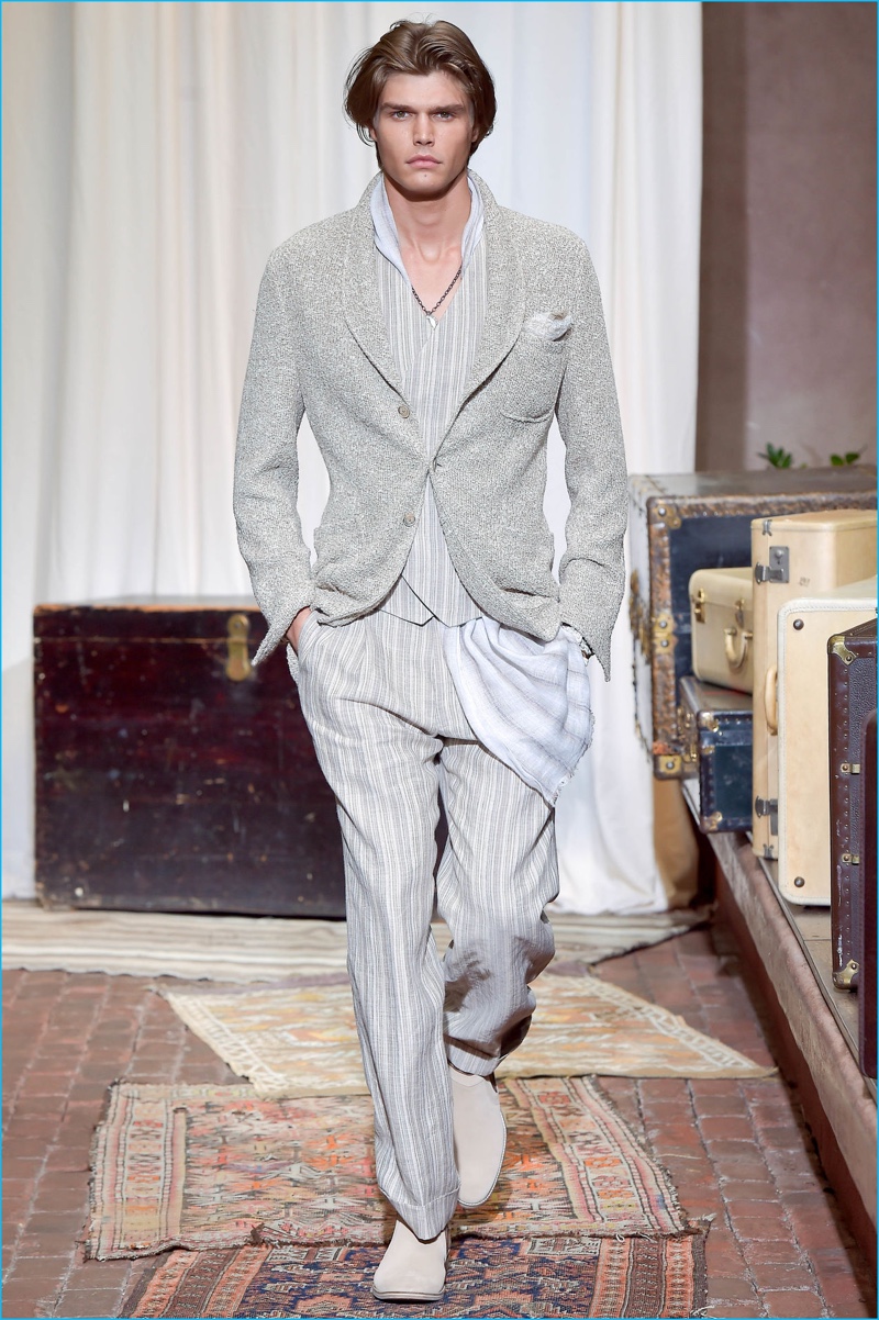 Jesse Gwin embraces tailored neutrals with subtle stripes as he walks during Joseph Abboud's spring-summer 2017 show.