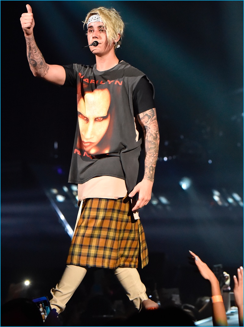 Pictured on his Purpose tour, Justin Bieber wears a custom look from Fear of God. The singer rocks a Marilyn Manson sleeveless t-shirt with a plaid kilt.