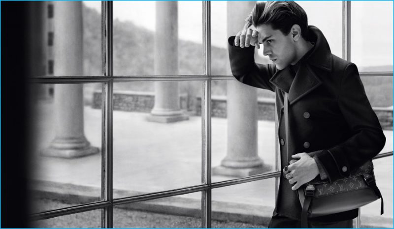 Xavier Dolan fronts Louis Vuitton's fall-winter 2016 men's campaign, sporting a peacoat with a Messenger Voyager PM and Traveller Stamp Signet Ring.