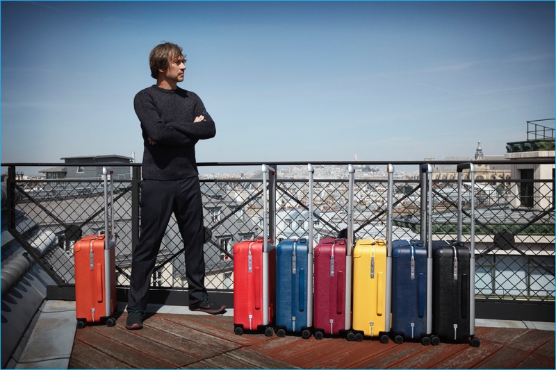 Design Marc Newson photographed with Louis Vuitton's rolling trunks, available in rainbow hued Epi leather.
