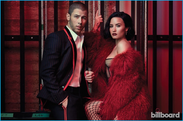 Styled by Jeff Kim, Nick Jonas poses for a picture with Demi Lovato, wearing a Givenchy suit.