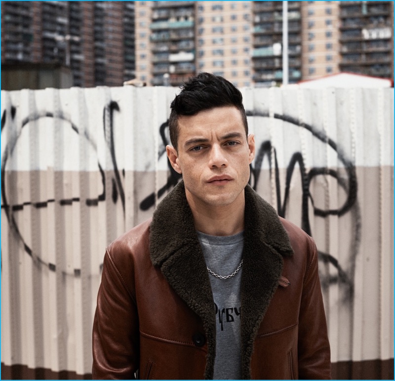 Rami Malek sports a leather and shearling Coach jacket with a Gosha Rubchinskiy t-shirt and David Yurman chain necklace.