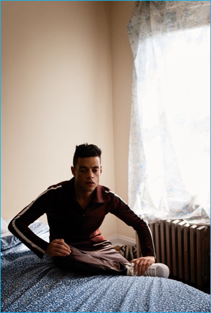 Rami Malek sports a Burberry track jacket with Rag & Bone pants and Adidas sneakers.