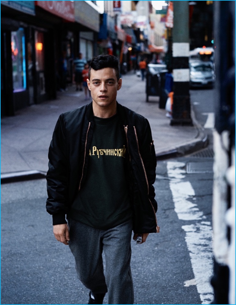 Rami Malek goes casual in a Givenchy bomber jacket, worn with a Gosha Rubchinskiy t-shirt, Comme des Garçons pants and Reebok sneakers.