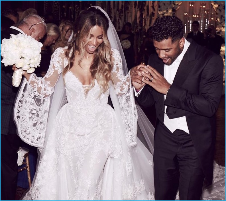 Donning a dashing Giorgio Armani Made to Measure number, Russell Wilson weds Ciara, who wore a Cavalli Couture wedding gown.