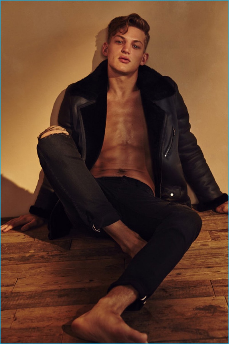 Sebastian Sauvé rocks a shearling coat and ripped denim jeans from BLK DNM.