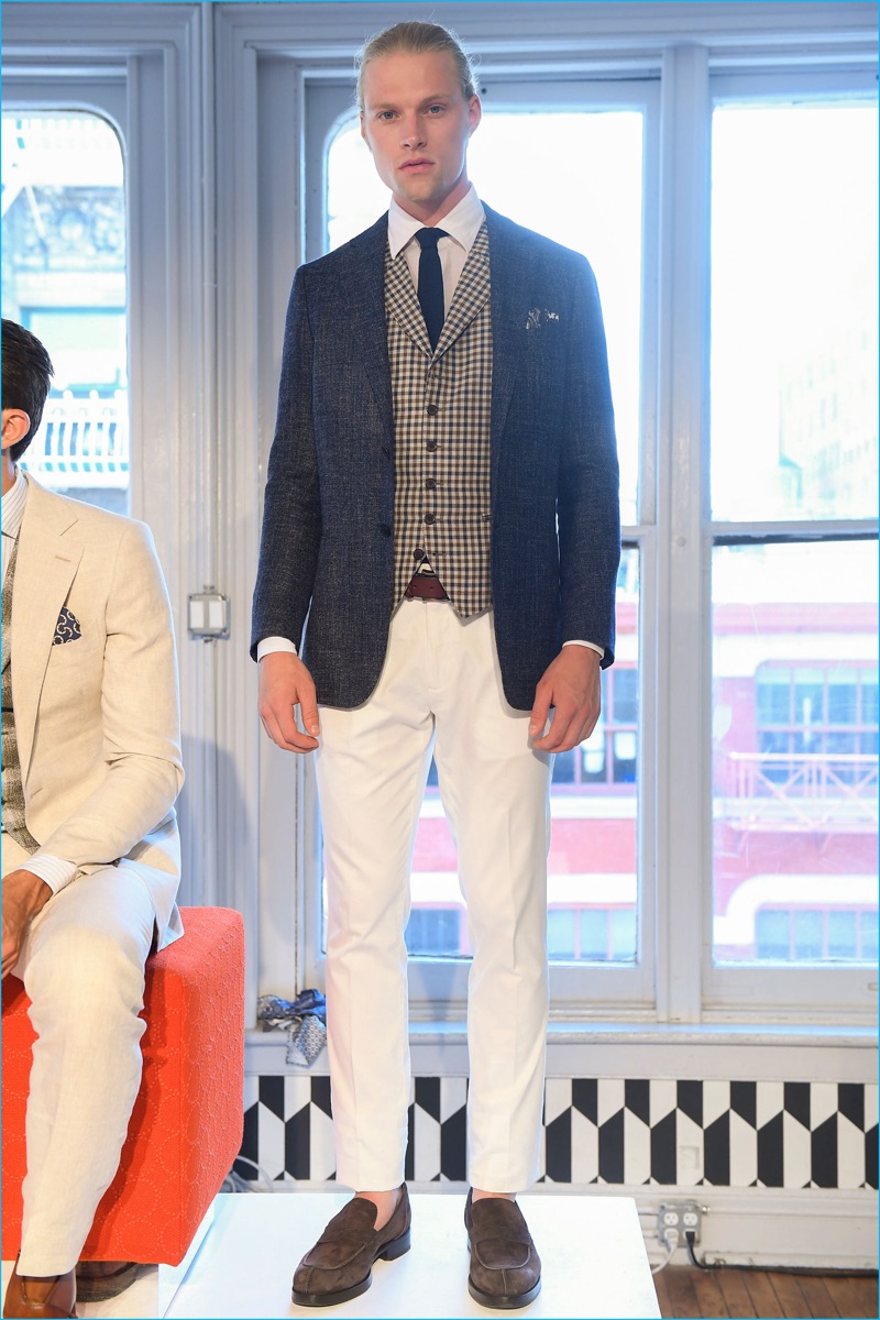 A country cool is front and center as Suitsupply pairs white trousers with a smart blazer and waistcoat.