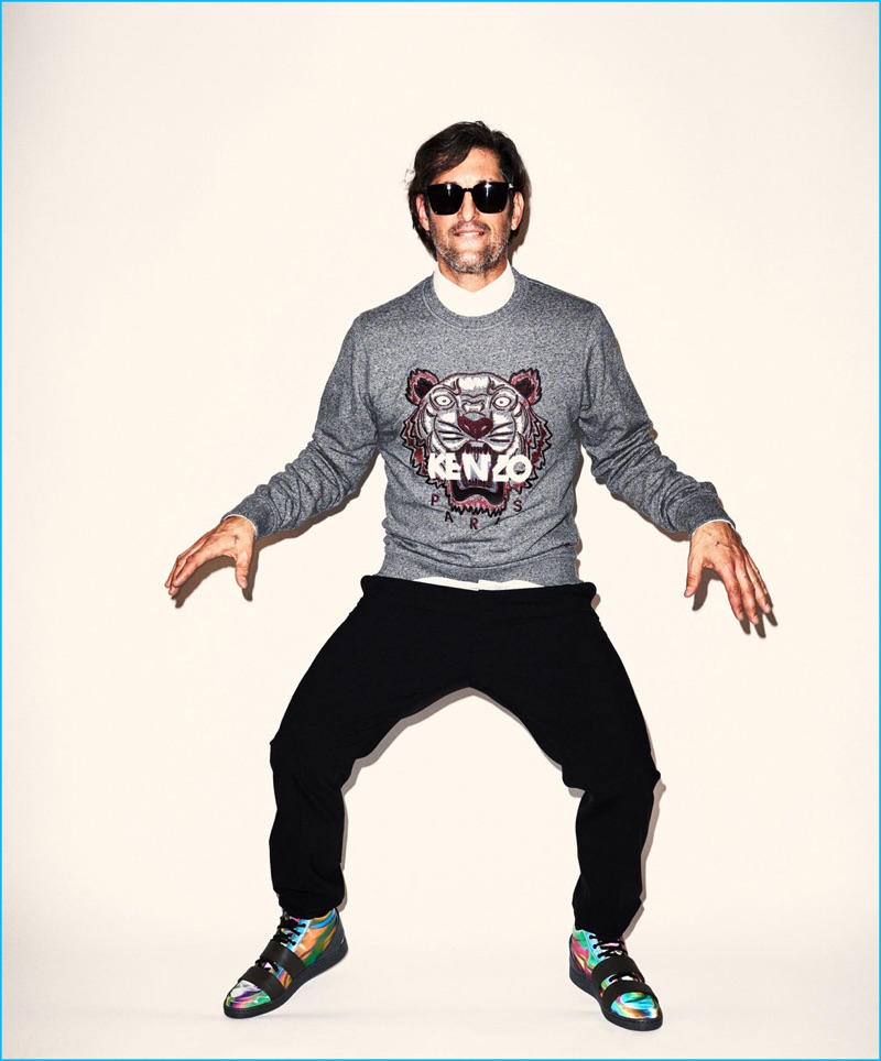 Tony Ward brings the quirky antics in a Kenzo tiger sweatshirt and trousers, paired with Puma McQ sneakers.