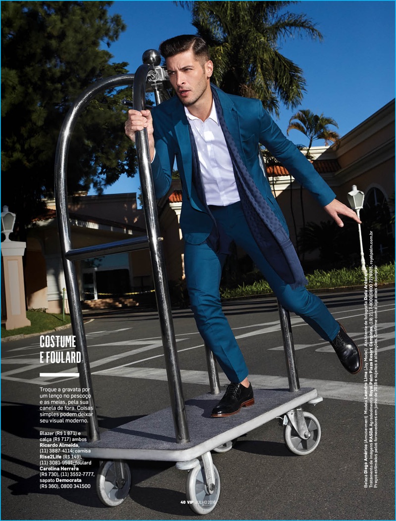 Leandro Lima takes a luggage  cart for a spin in a sharp suit from Ricardo Almeida. The model makes his look casual with a scarf instead of a tie.
