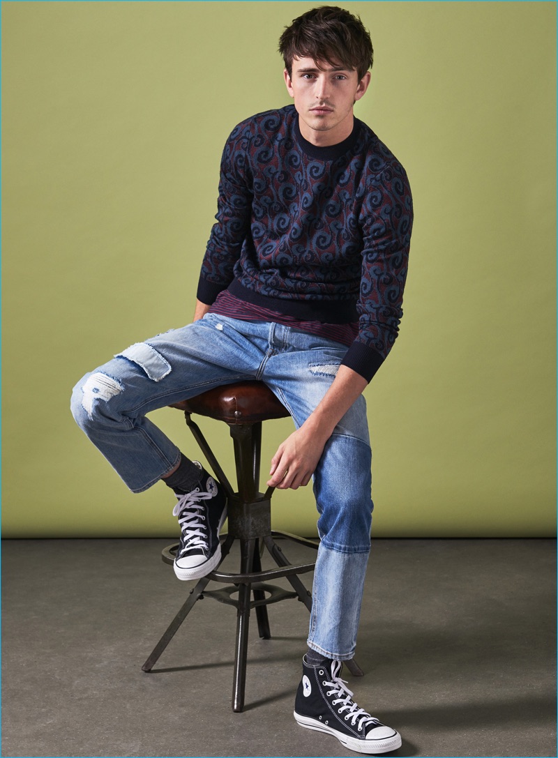 Alex Dunstan wears sweater Dries Van Noten, striped t-shirt Diesel, denim jeans H&M, and hi-top sneakers Converse.