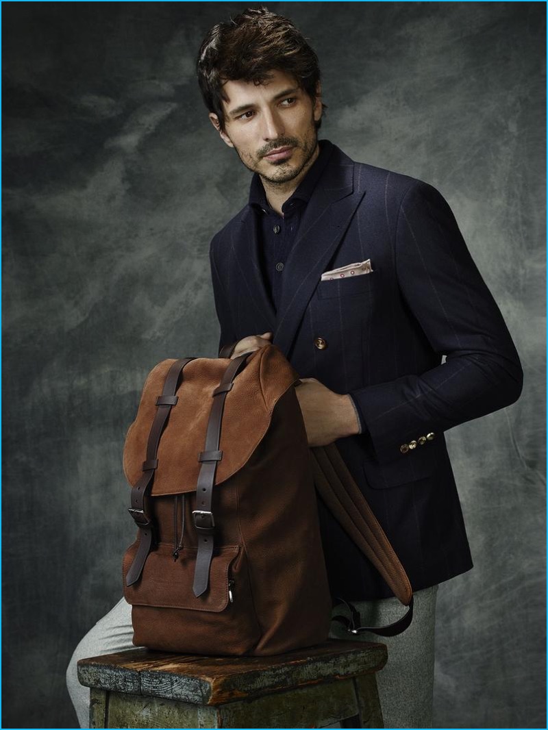 Modeling a double-breasted jacket, Andres Velencoso poses with one of Brunello Cucinelli's fall-winter 2016 backpacks. 