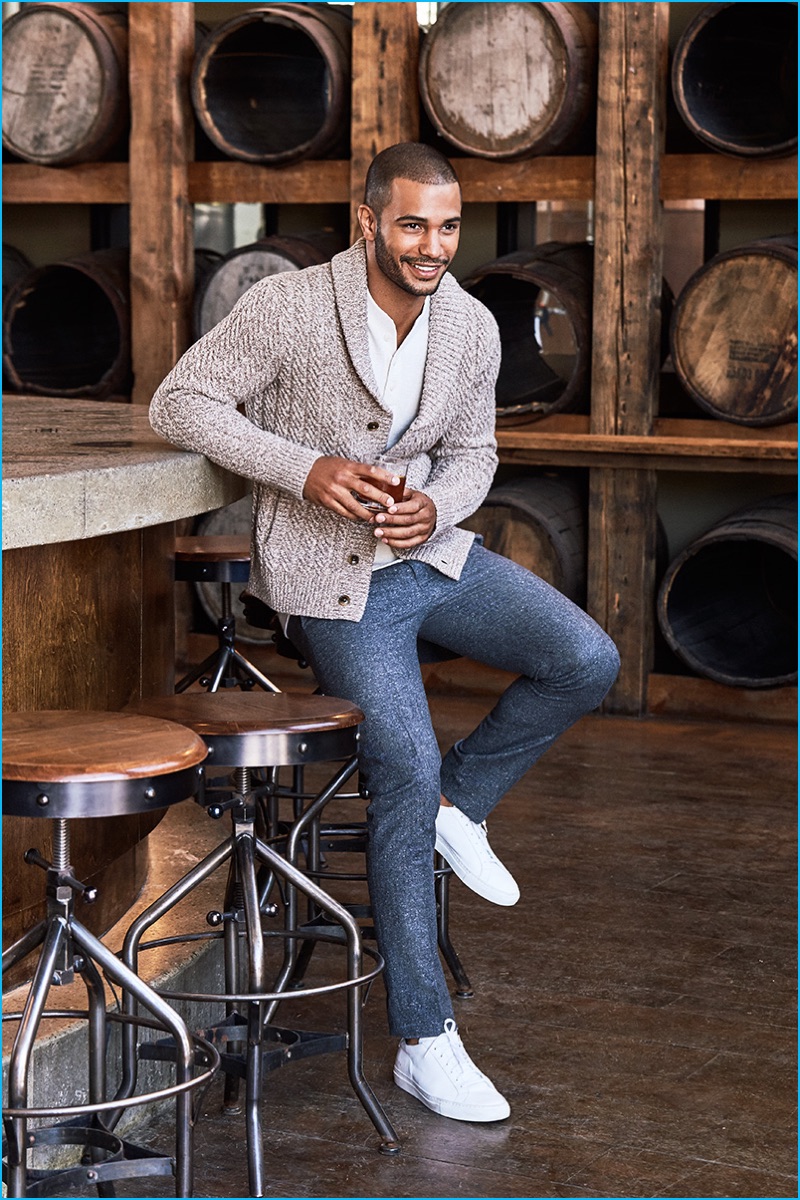 Nathan Owens is all smiles in a shawl neck cardigan sweater from Bonobos.