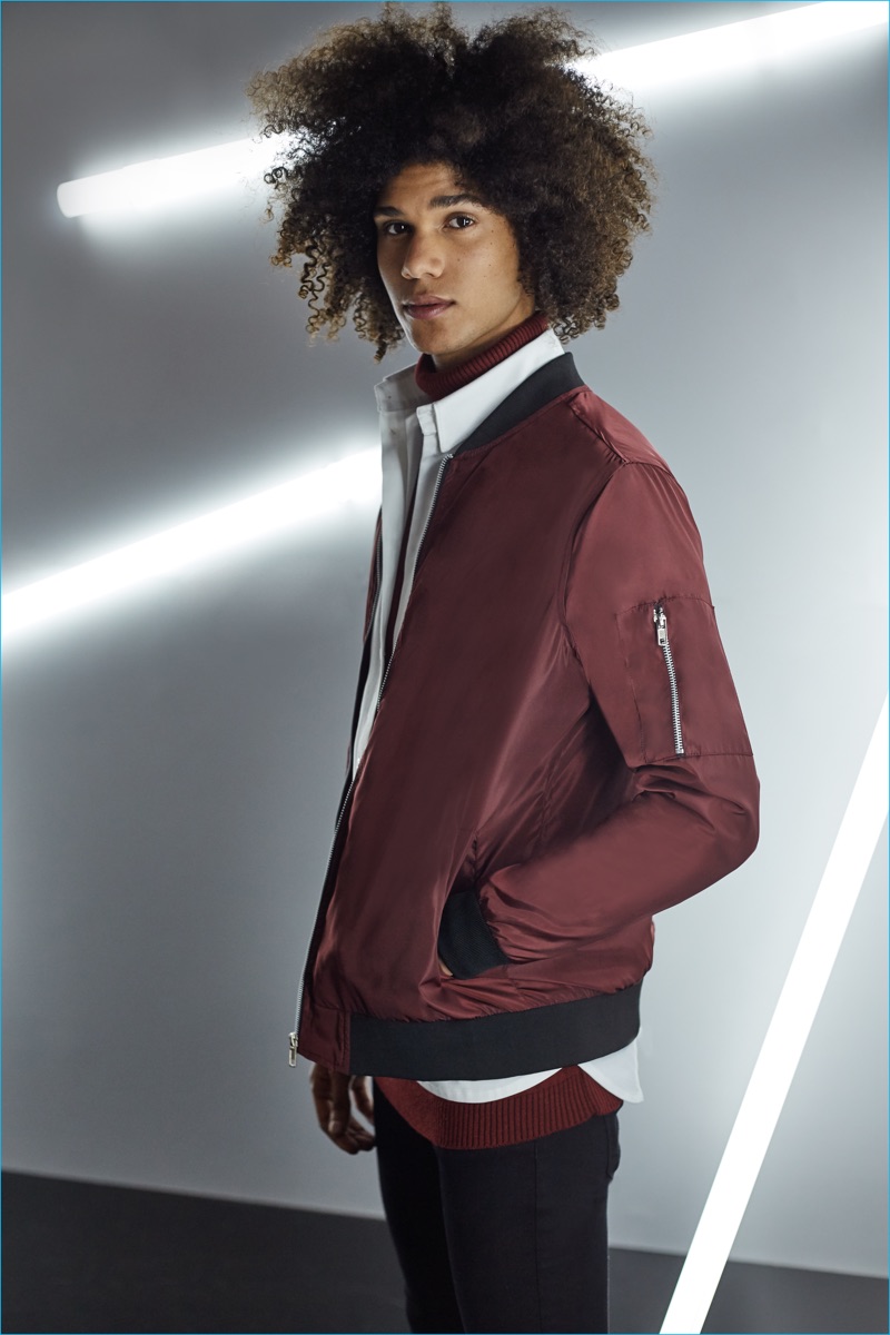 Bruno Fabre rocks a burgundy bomber jacket from BoohooMAN's holiday 2016 collection.