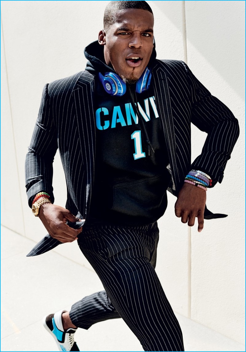 Cam Newton wears a pinstripe Ralph Lauren suit with a King Threads hoodie. » Cam Newton is GQ's Superman for September Cover Story Cam Newton wears a pinstripe Ralph Lauren suit with a King Threads hoodie.