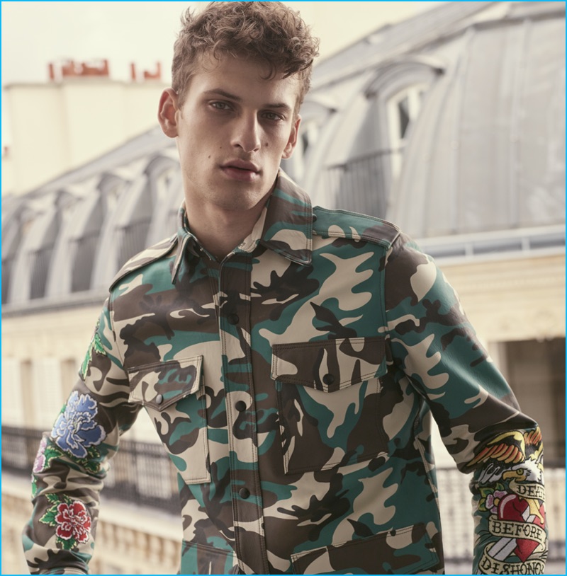 David Trulik rocks a camouflage jacket for Cesare Paciotti's Wild Dagger fall-winter 2016 campaign.