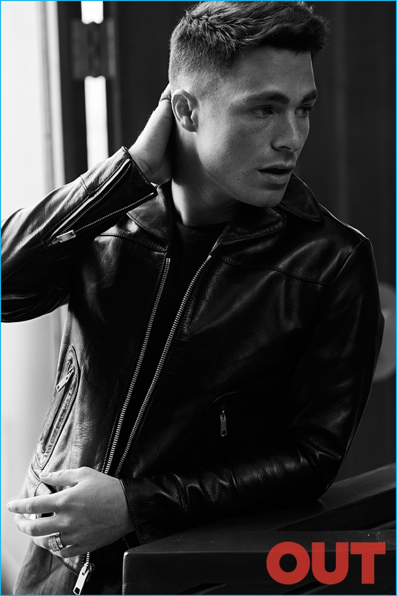 Colton Haynes poses for a black & white image, wearing a John Varvatos shirt with a Marc Jacobs leather jacket.