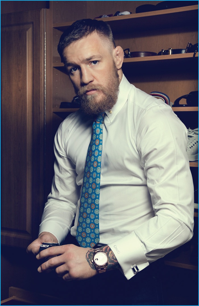 Conor McGregor pictured in a fitted white dress shirt and tie for Haute Time.