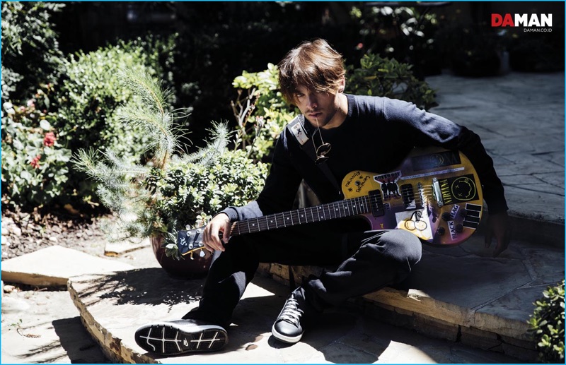 Dylan Sprayberry poses with a guitar for the latest issue of Da Man magazine.