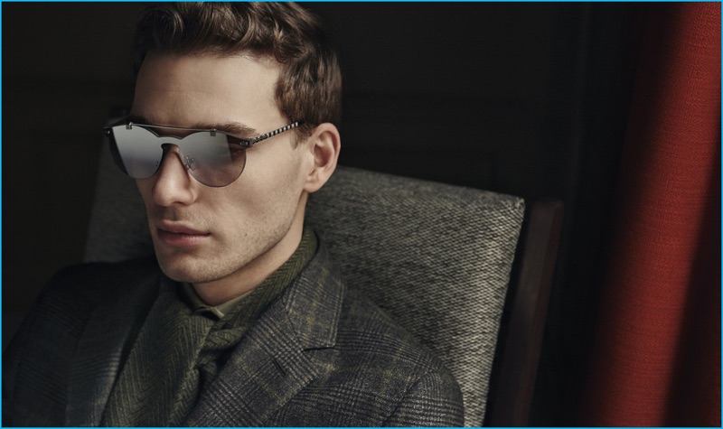 Nikola Jovanovic sports modern sunglasses and a wool check suit Ermenegildo Zegna's fall-winter 2016 collection.