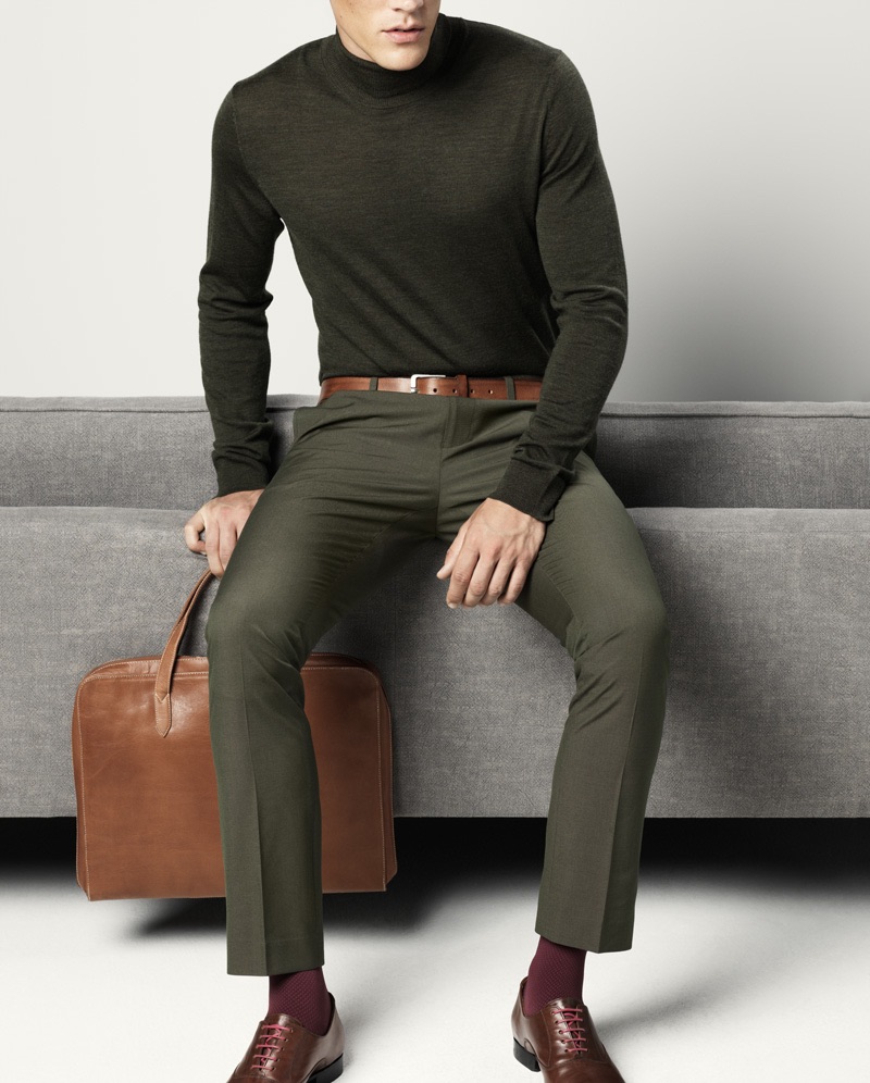 Jimmy wears turtleneck sweater Samsøe & Samsøe, trousers Cedarwood State, belt Drykorn, bag Fabienne Chapot, socks Item M6, and shoes Undandy.