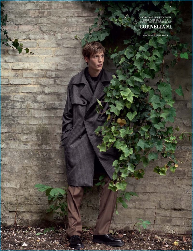 Felix Gesnouin wears an oversized trench coat from Corneliani. 