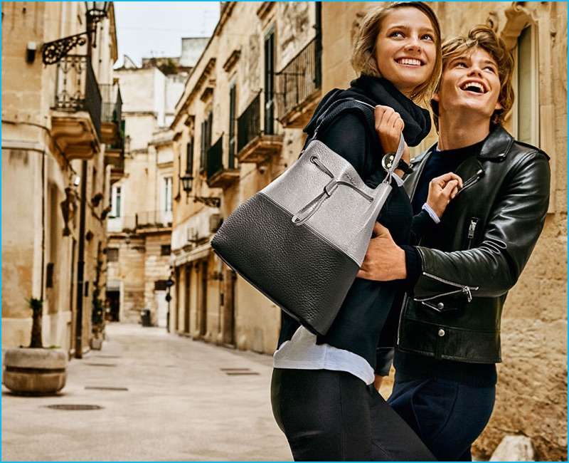 Models Jordan Barrett and Ine Neefs embrace for Furla's fall-winter 2016 campaign.