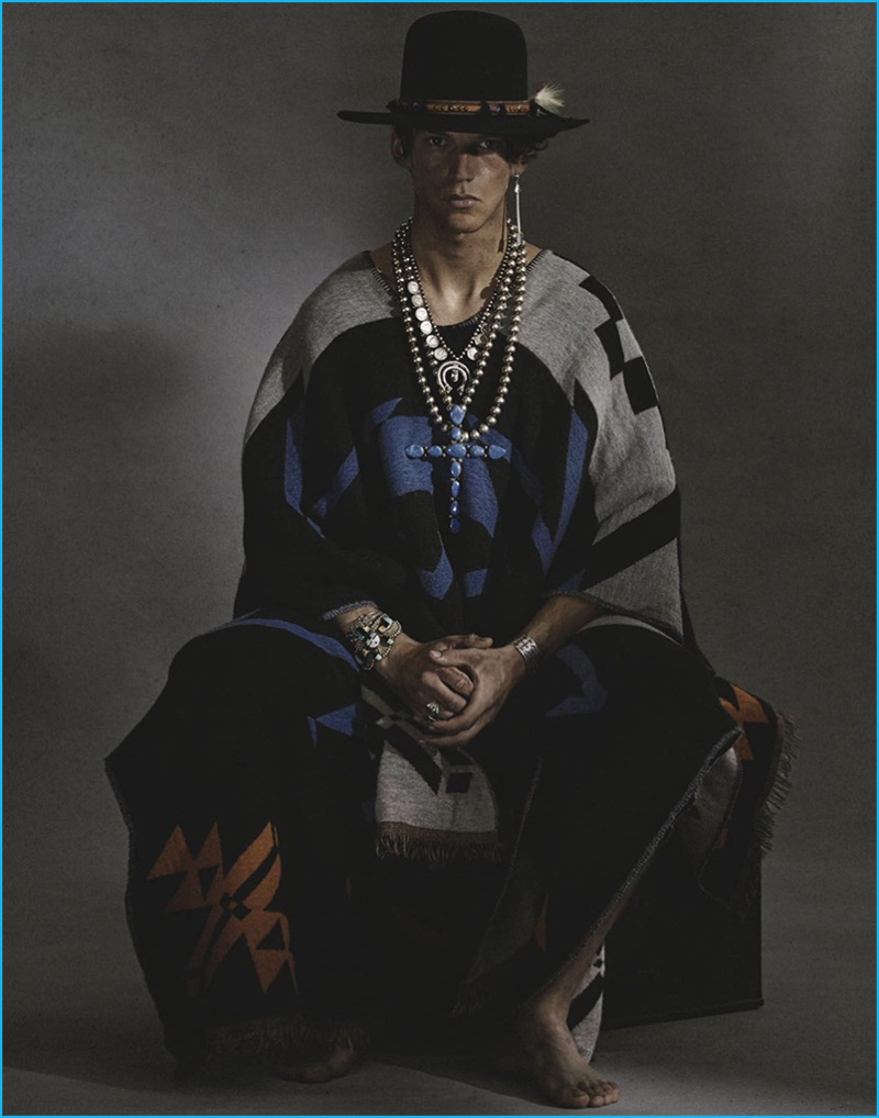 Miles Hurley makes a fashion statement in a Marcelo Burlon County of Milan poncho.