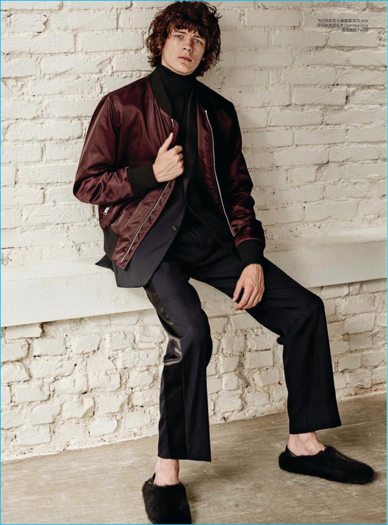 Fionnan Byrne-Perkins models a burgundy bomber jacket from Parisian label Ami.