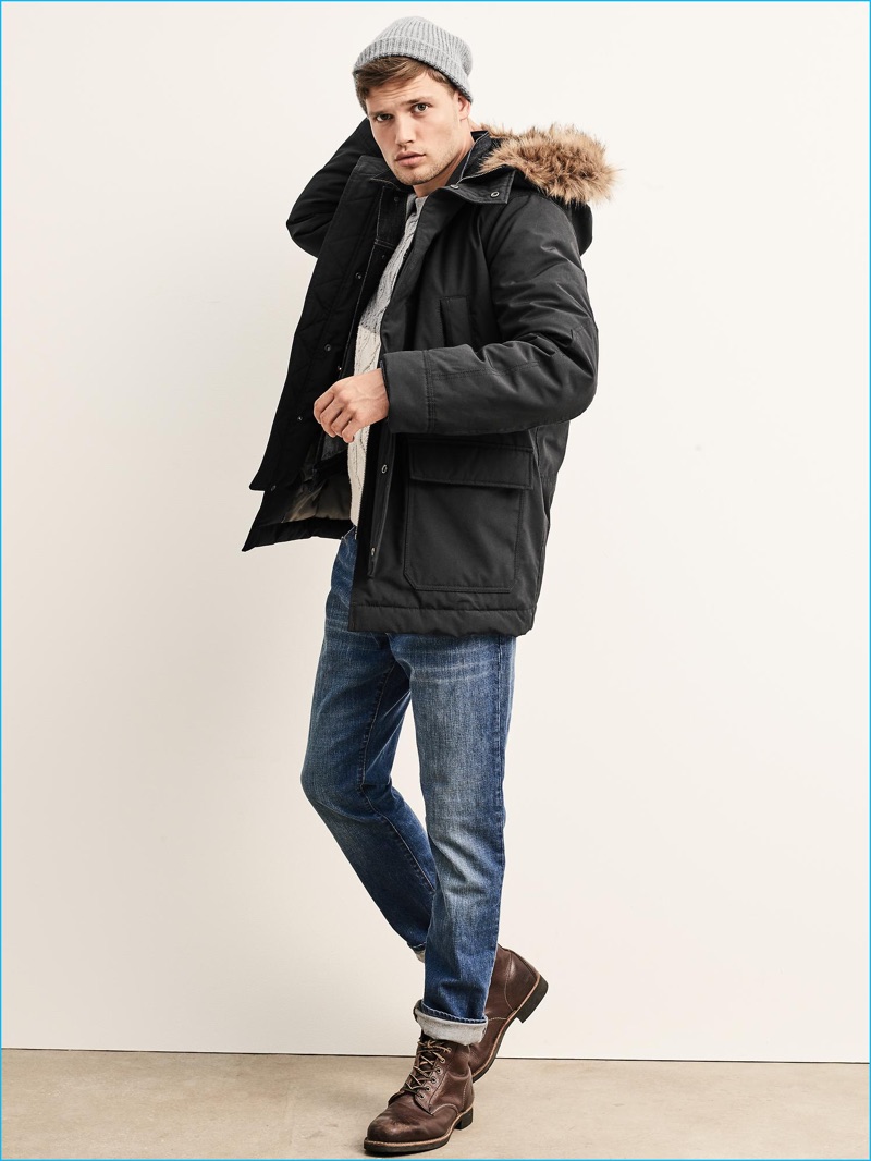 Bracing for the cold weather, Stefan Pollmann models Gap's ColdControl Max Snorkel coat with distressed denim jeans and brown leather boots.