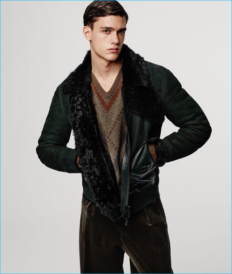 Xavier Serrano dons a suede jacket and autumnal hued v-neck sweater from Giorgio Armani's fall-winter 2016 collection.