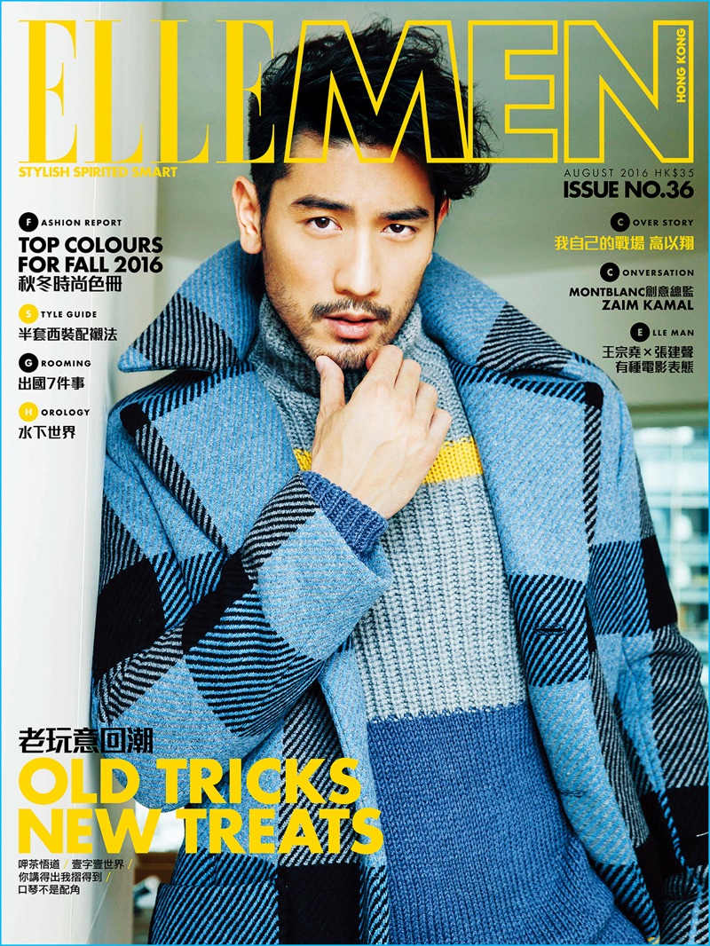 Godfrey Gao covers the August 2016 issue of Elle Men Hong Kong in a plaid coat and knit sweater from Fendi.