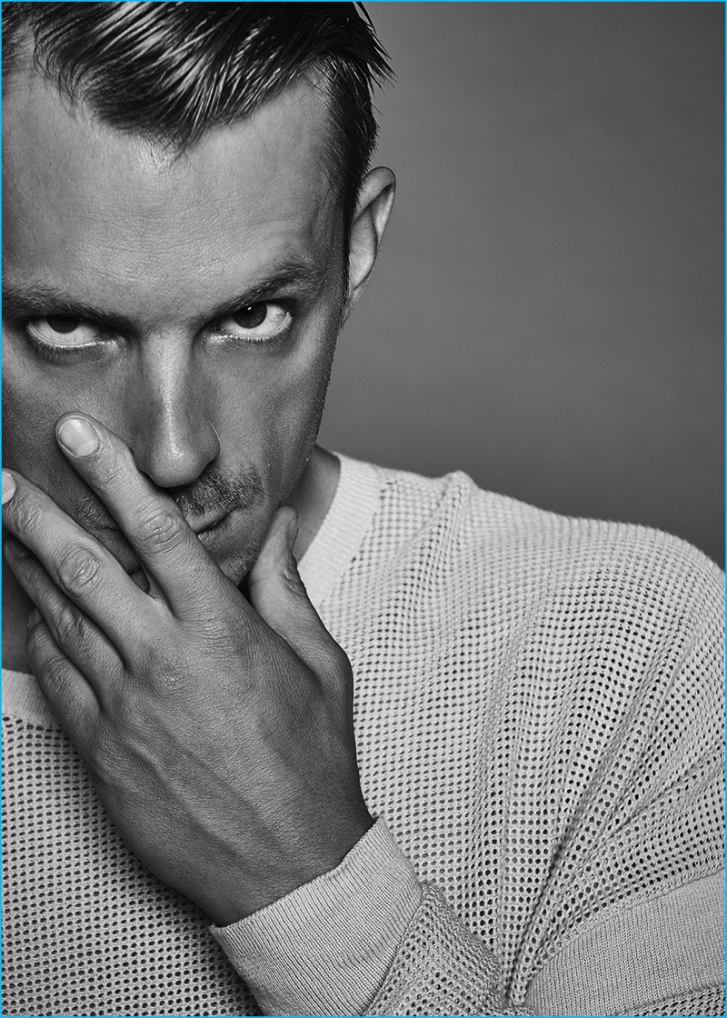 Joel Kinnaman pictured in an open weave sweater from AllSaints.