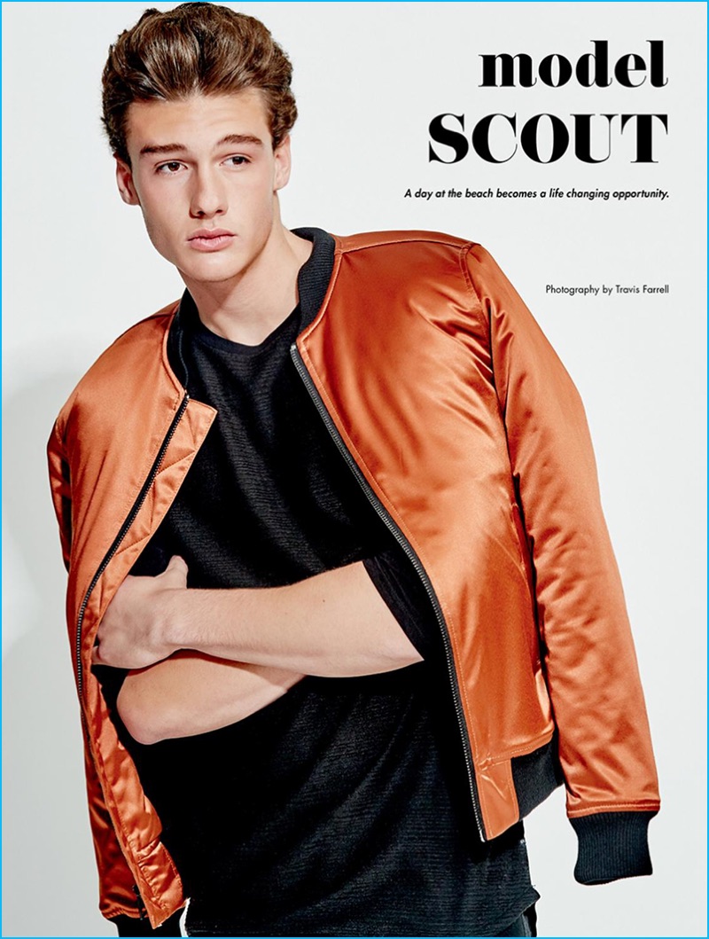 Photographed by Travis Farrell, John Economou rocks an orange bomber jacket from Guess.